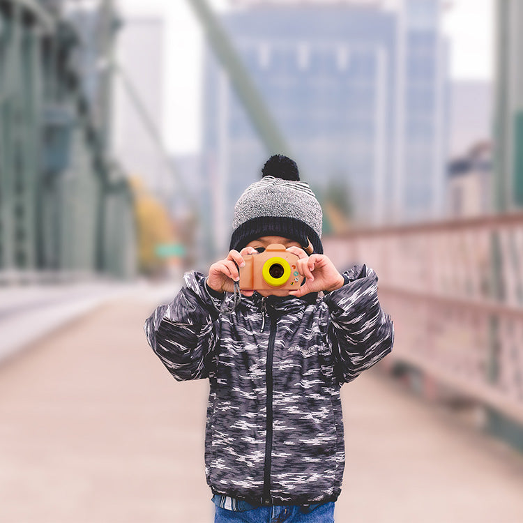 myFirstCamera Lifestyle image of a boy holding camera